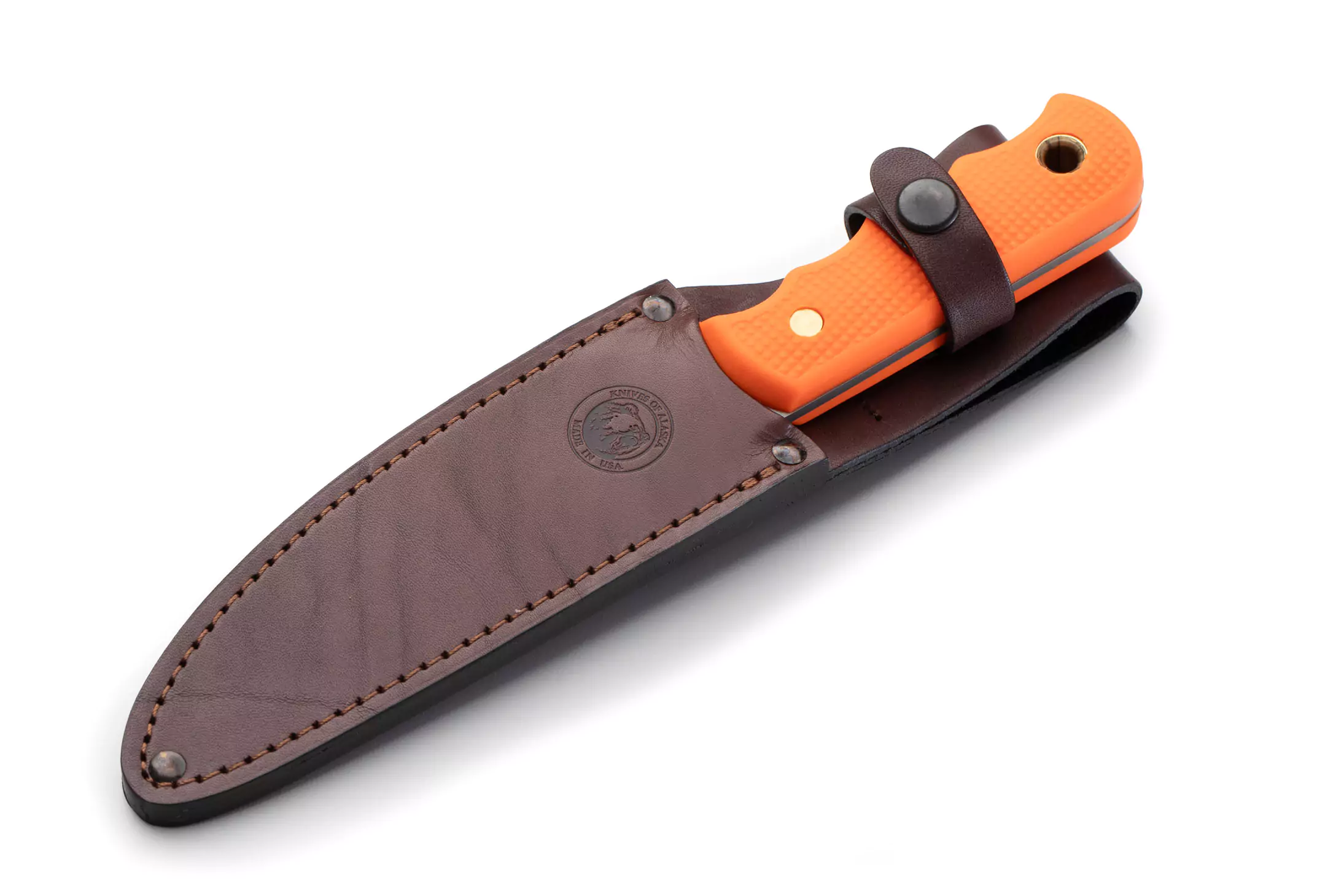 Knives of Alaska Bush Camp knife with orange Suregrip handle secured in a brown leather sheath.