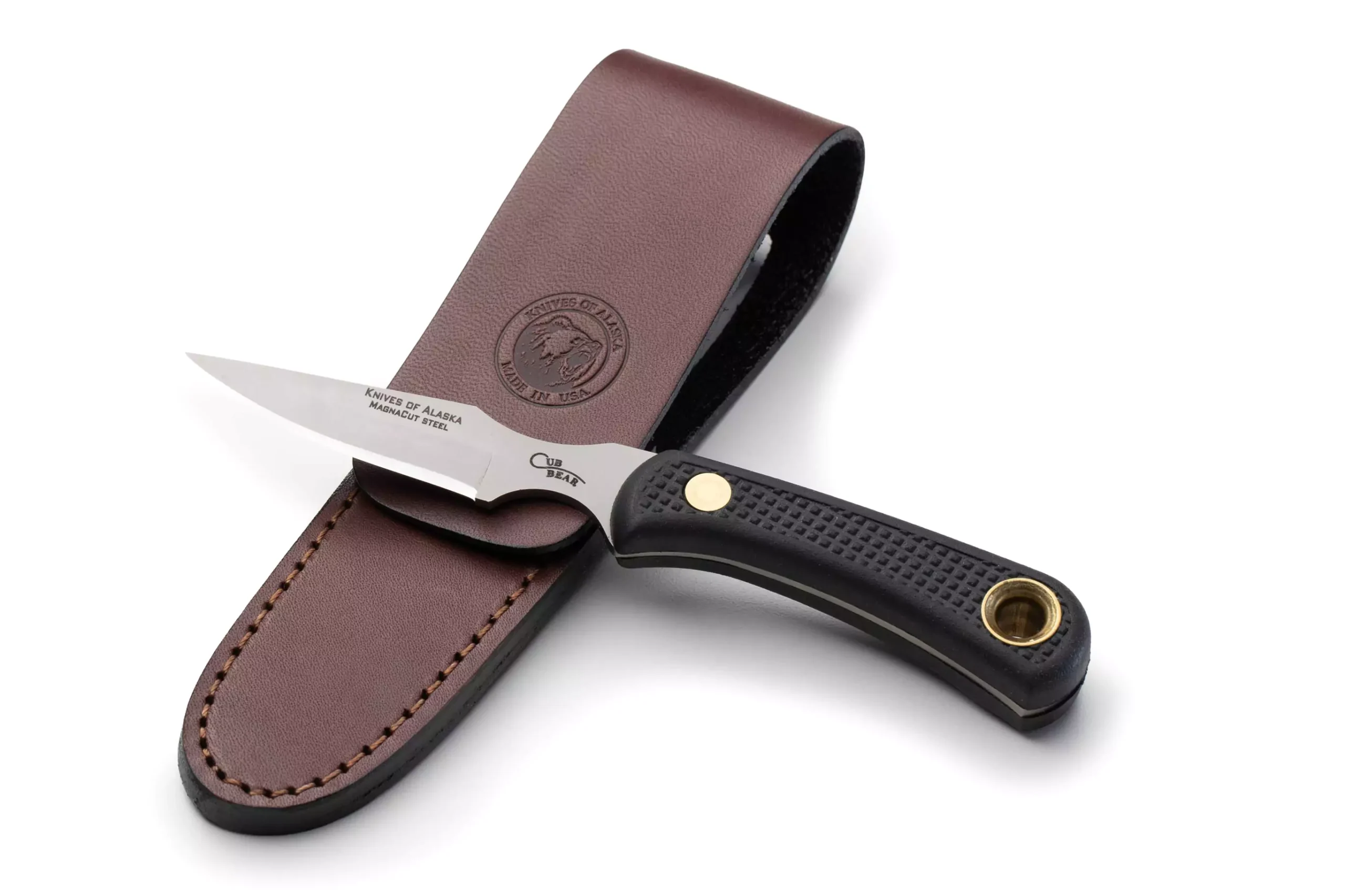 Knives of Alaska Cub Bear knife with Magnacut steel and black Suregrip handle resting on leather