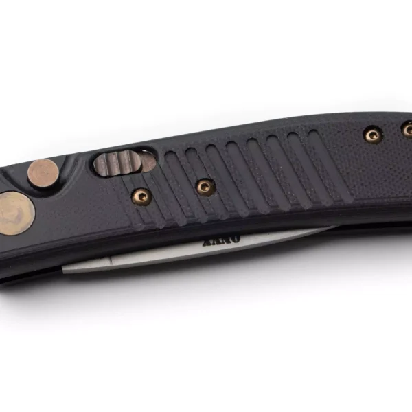 Knives of Alaska Onyx Auto folding knife in closed position, featuring an OD black textured grip, bronze hardware, and partially visible Magnacut blade.