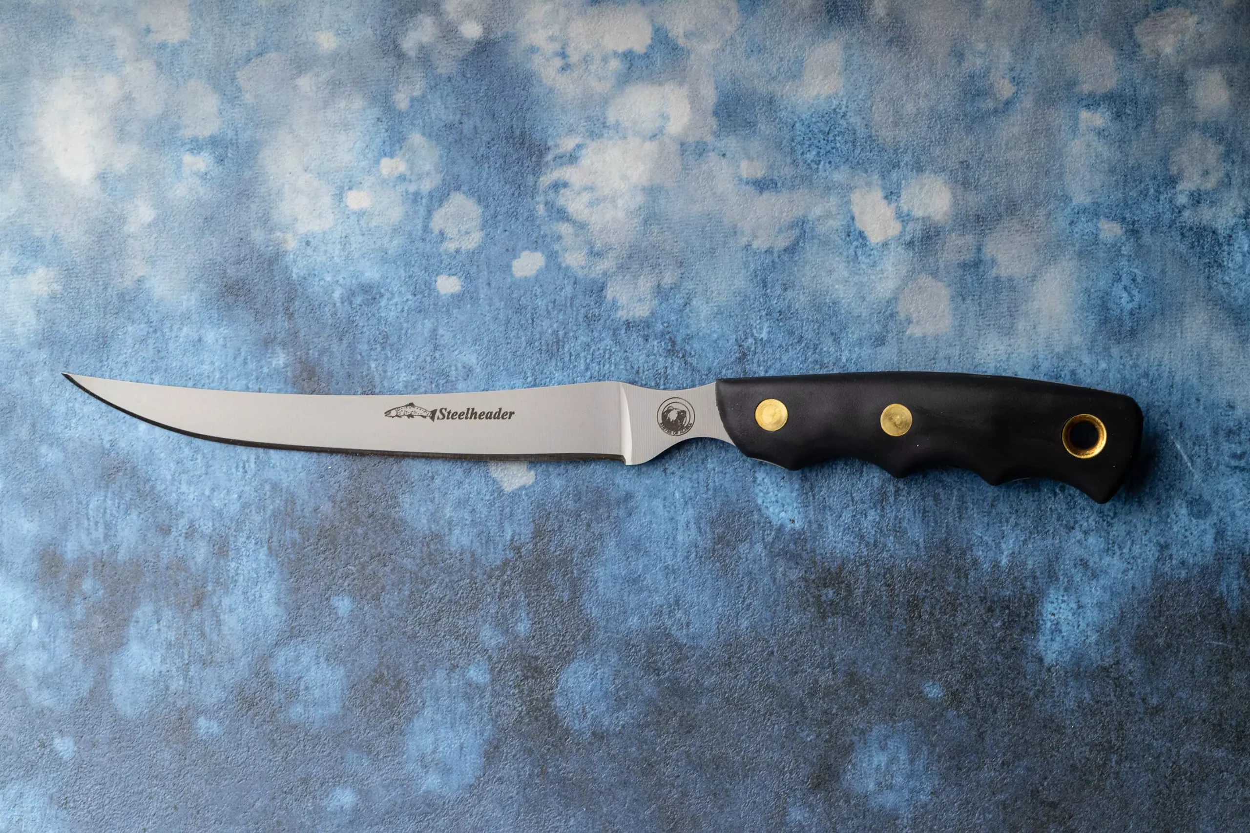 Steelheader fillet knife with black Suregrip handle and thin flexible blade