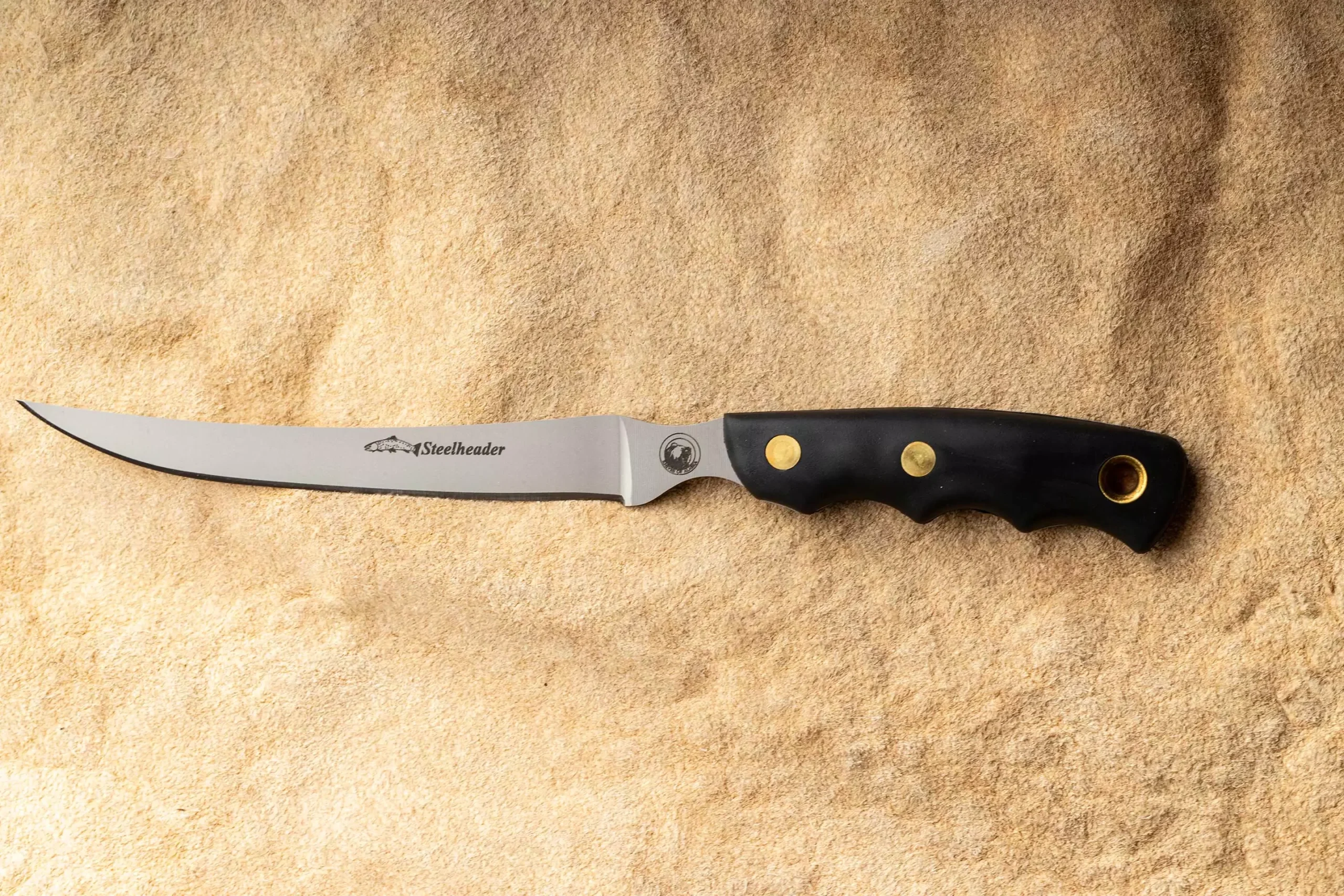 Steelheader fillet knife with black Suregrip handle and thin flexible blade