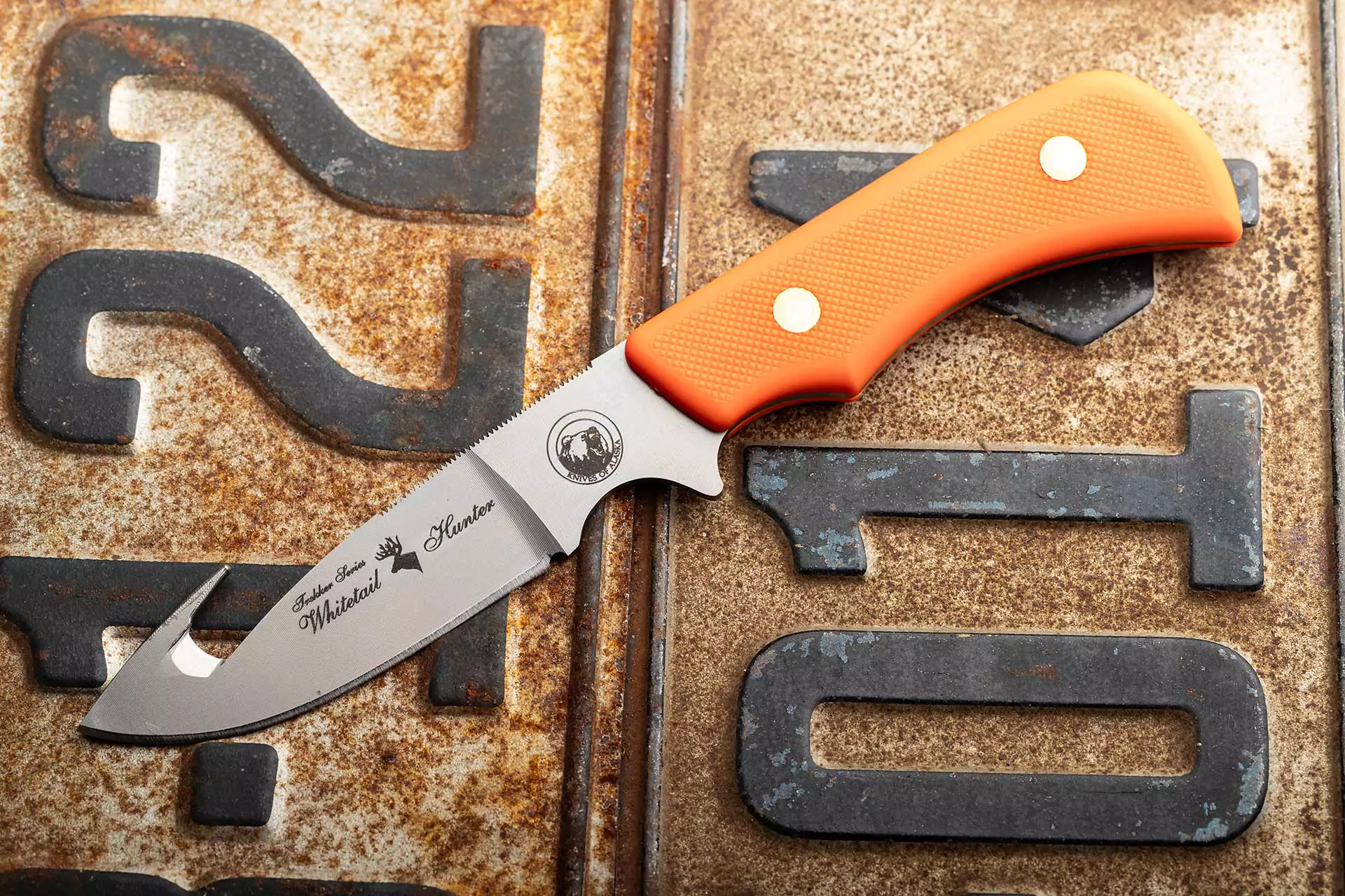 Trekker Series Whitetail Hunter knife with orange Suregrip handle and gut hook blade