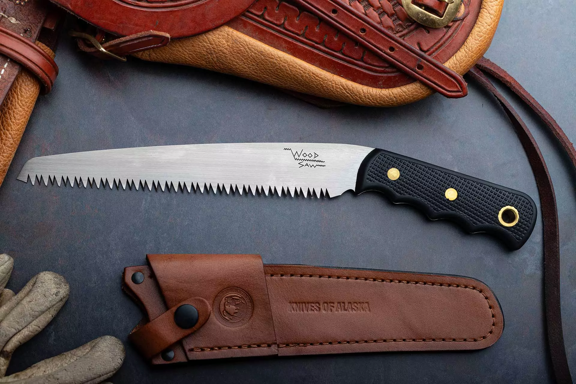 Knives of Alaska wood saw with Suregrip handle and leather sheath