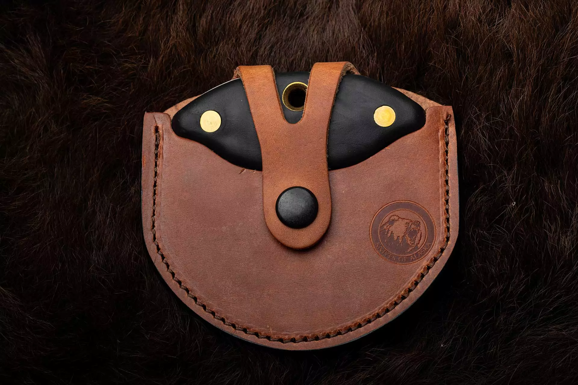 Magnum Ulu knife with Suregrip handle sheathed in brown leather case
