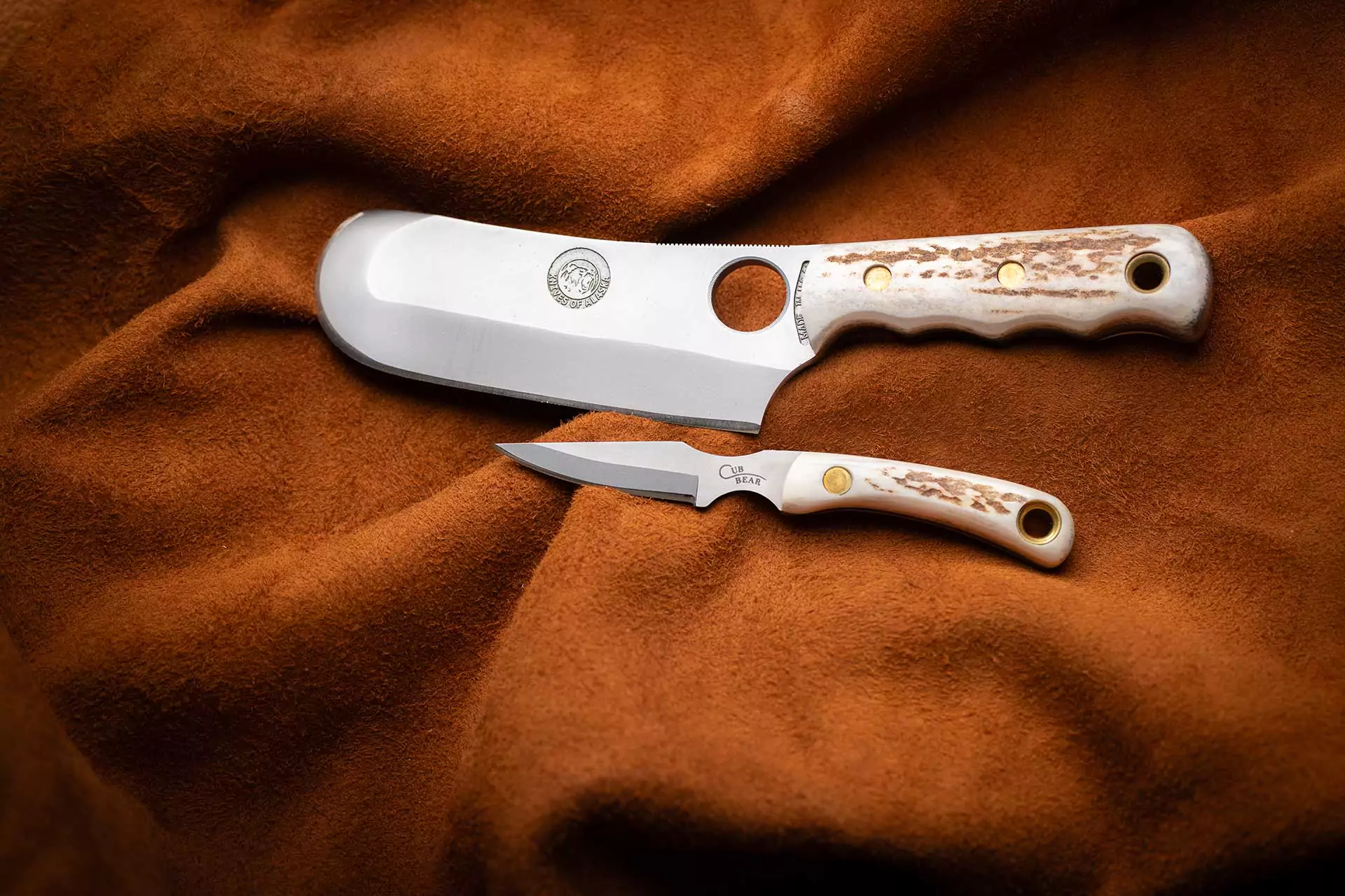 Brown Bear and Cub Bear knife combo with stag handles on suede background