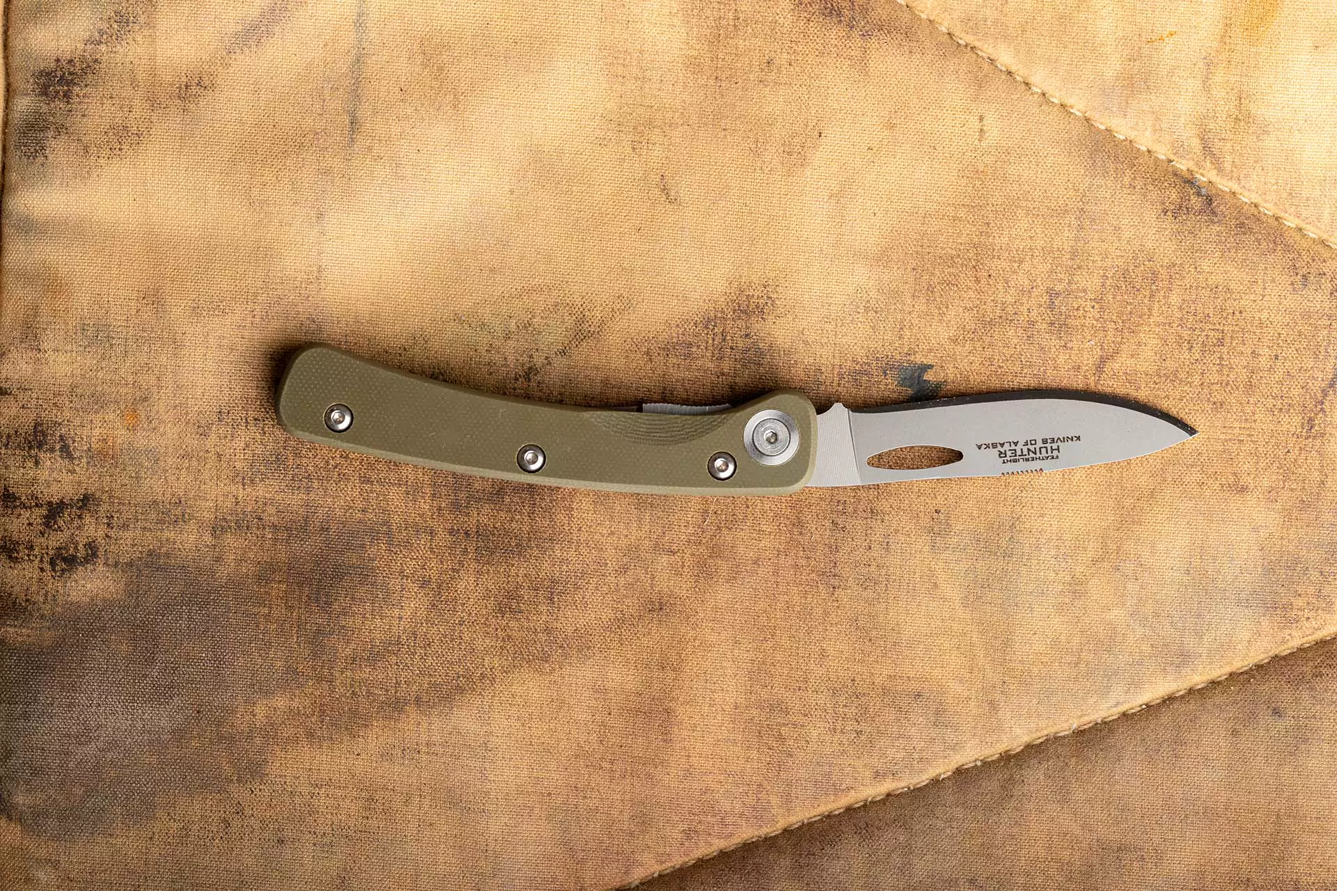 Featherlight Hunter folding knife with OD green G10 handle and drop-point D2 blade