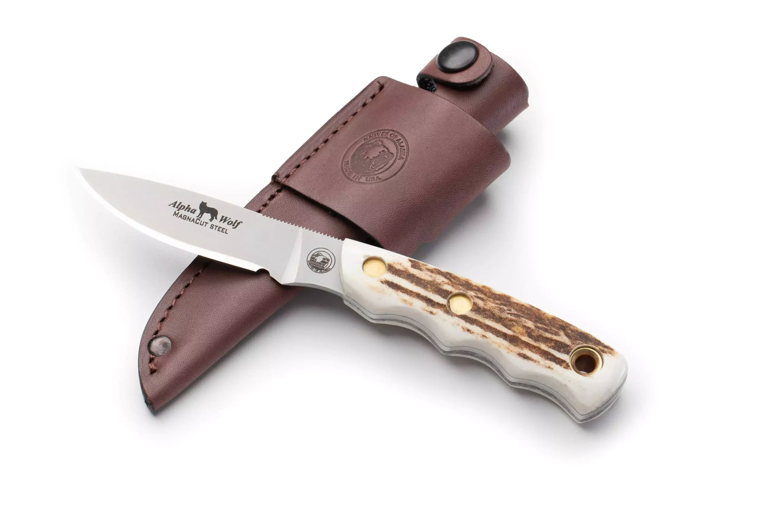 Alpha Wolf hunting knife with stag handle and Magnacut steel blade resting on brown leather sheath