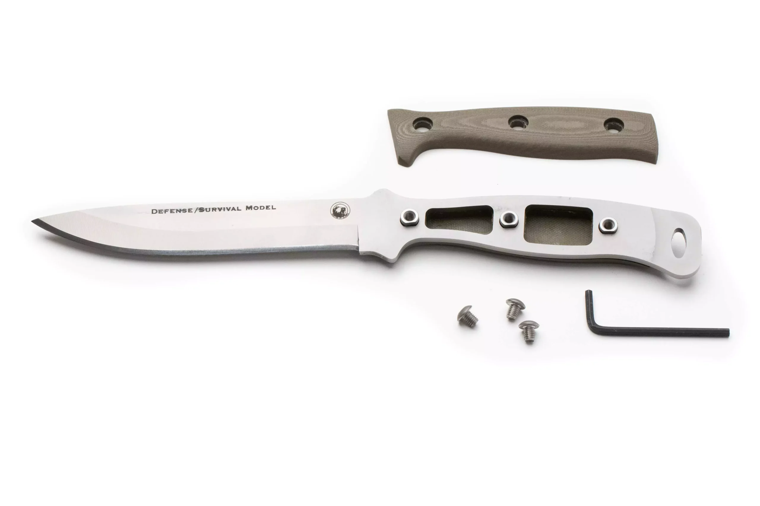 Disassembled Defense Survival knife showing D2 steel blade, skeletonized tang, G10 handle scale, screws, and hex key for assembly.
