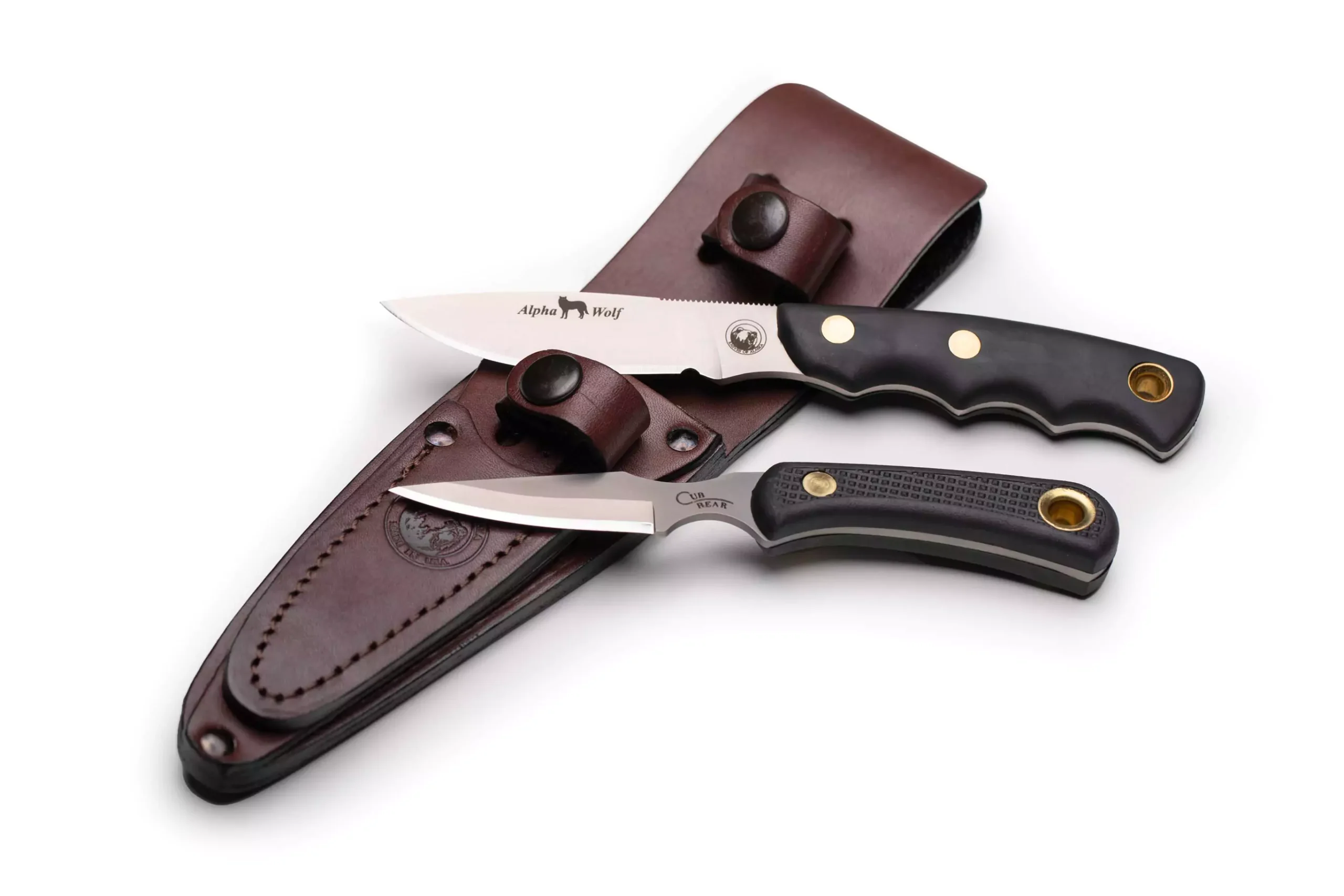 Alpha Wolf and Cub Bear knives with Suregrip handles displayed with leather sheath