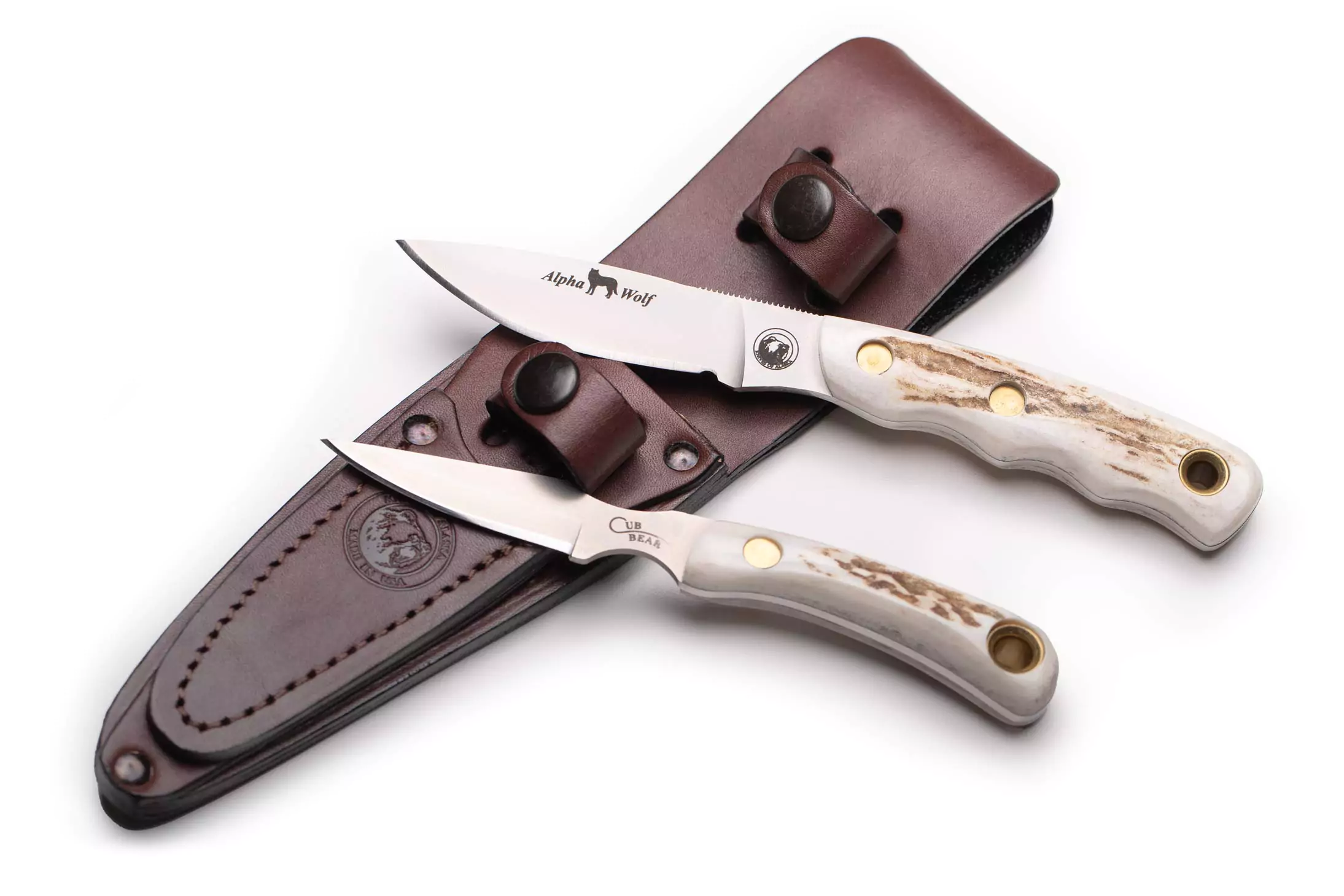 Alpha Wolf and Cub Bear knives with Suregrip handles displayed with leather sheath