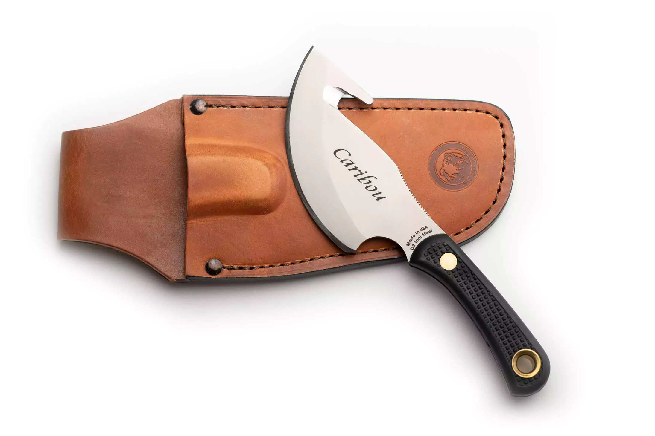 Knives of Alaska Caribou knife with black Suregrip handle and gut hook blade resting on leather sheath