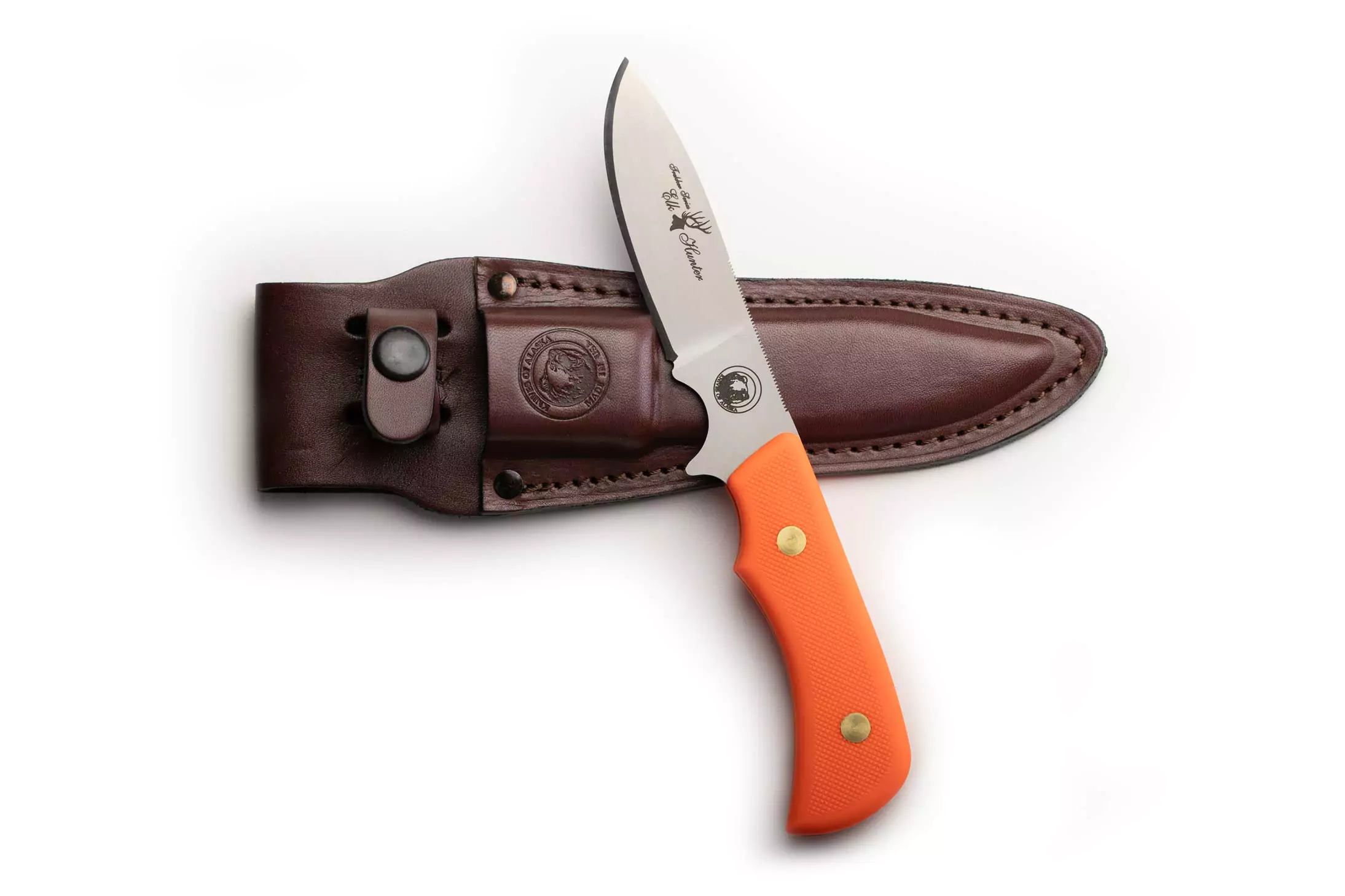 Trekker Elk Hunter knife with orange SureGrip handle and D2 tool steel blade displayed beside its leather sheath.