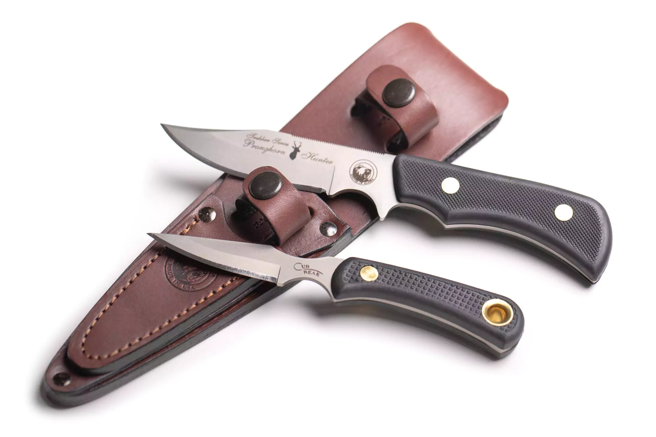 Trekker Pronghorn Hunter and Cub Bear knives with Suregrip handles displayed side by side on a white background.
