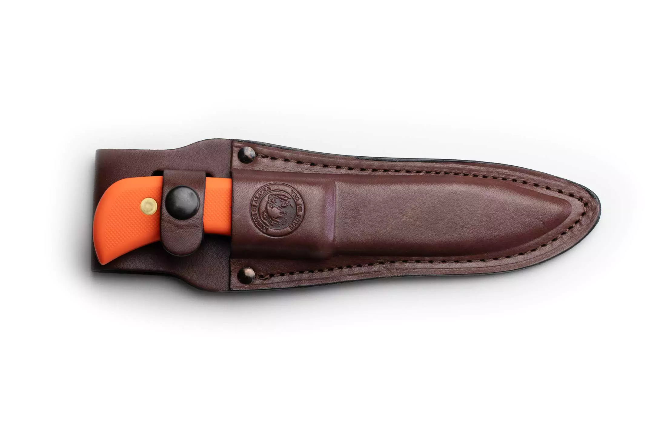Trekker Whitetail knife with orange Suregrip handle secured in a brown leather sheath.