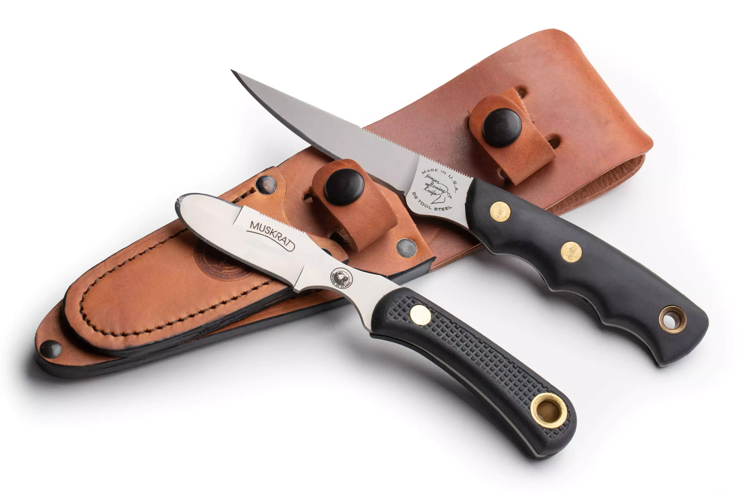 Jaeger and Muskrat knives with black Suregrip handles and D2 steel blades.