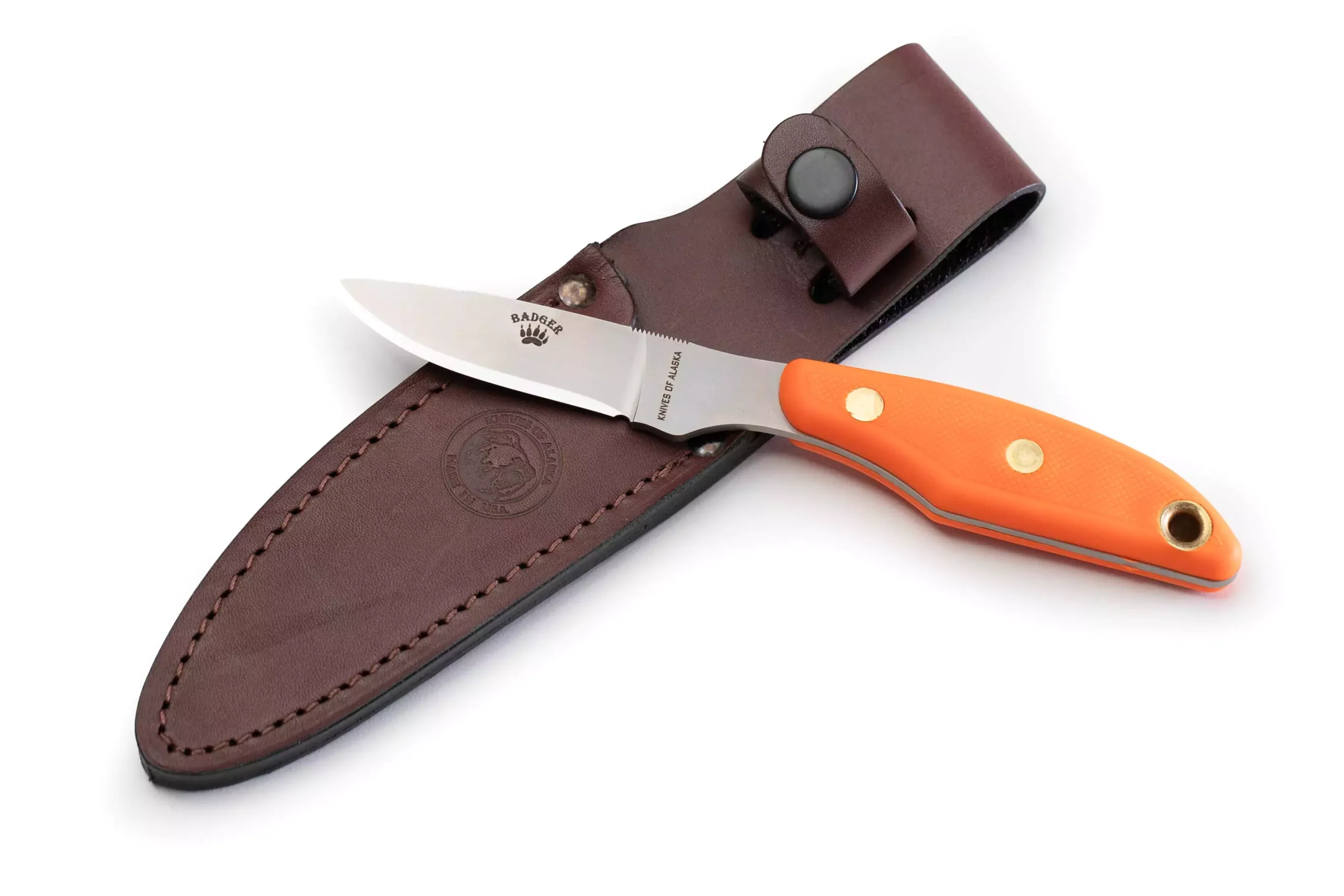 Knives of Alaska Badger knife displayed with leather sheath, featuring SureGrip handle and D2 tool steel blade.