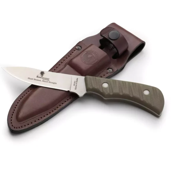 The Classic Hunter drop point hunting knife customized for Ron Spomer, shown with engraved blade and green textured handle resting on a brown leather sheath.