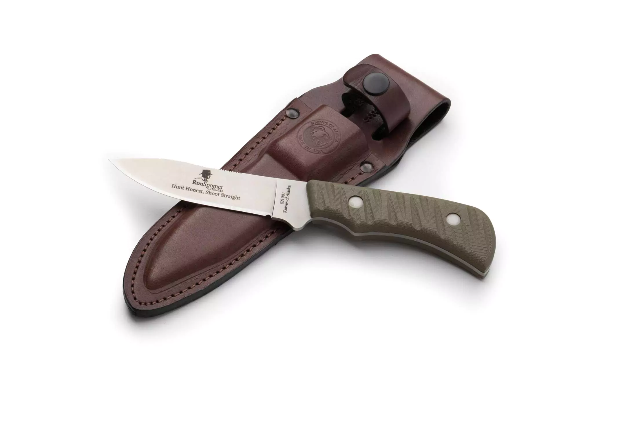 Ron Spomer edition Classic Hunter drop point hunting knife with green textured handle, engraved blade, leather sheath, and Knives of Alaska branded box on a natural fur surface.